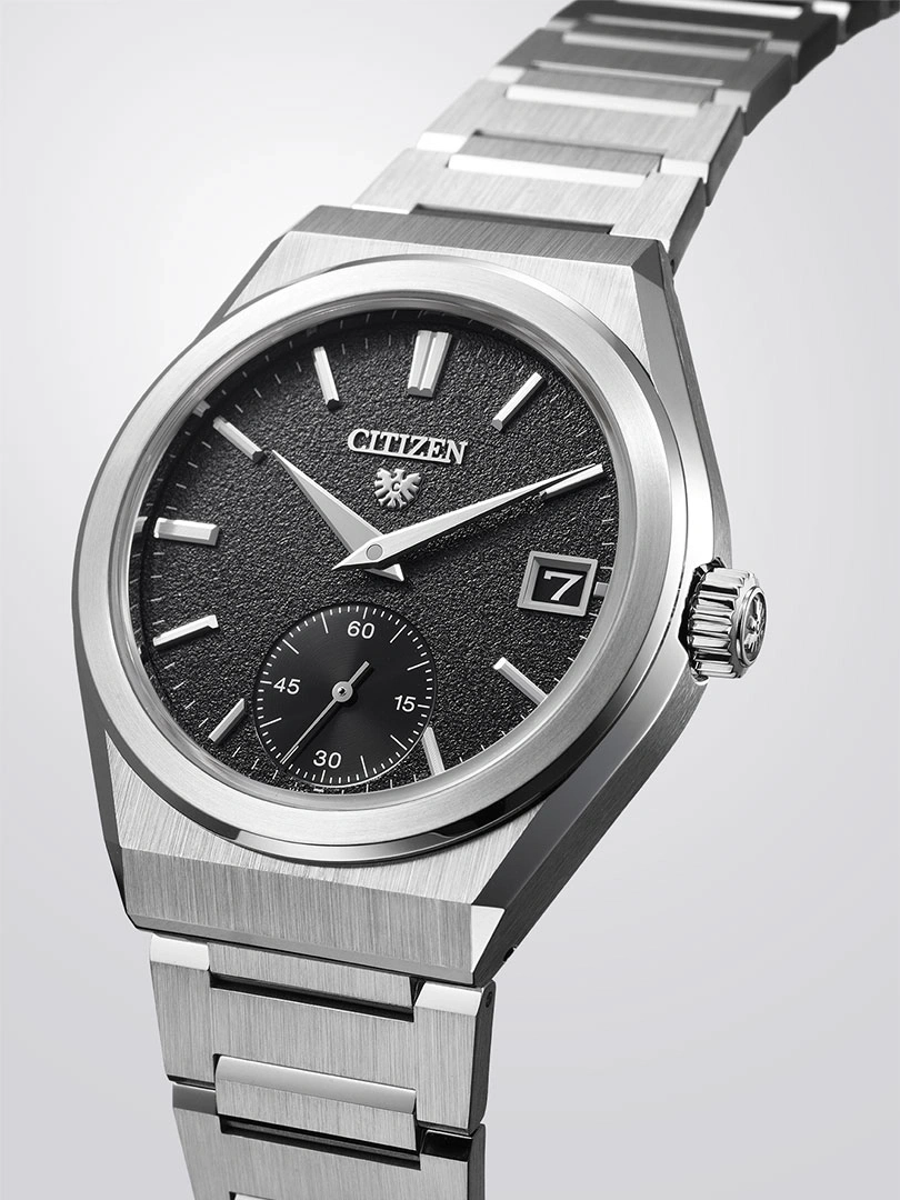 Citizen watch with black dial and silver bracelet, elegant design.