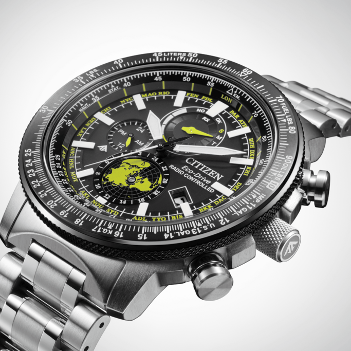 Citizen Eco-Drive watch with black face, world map, and silver band.