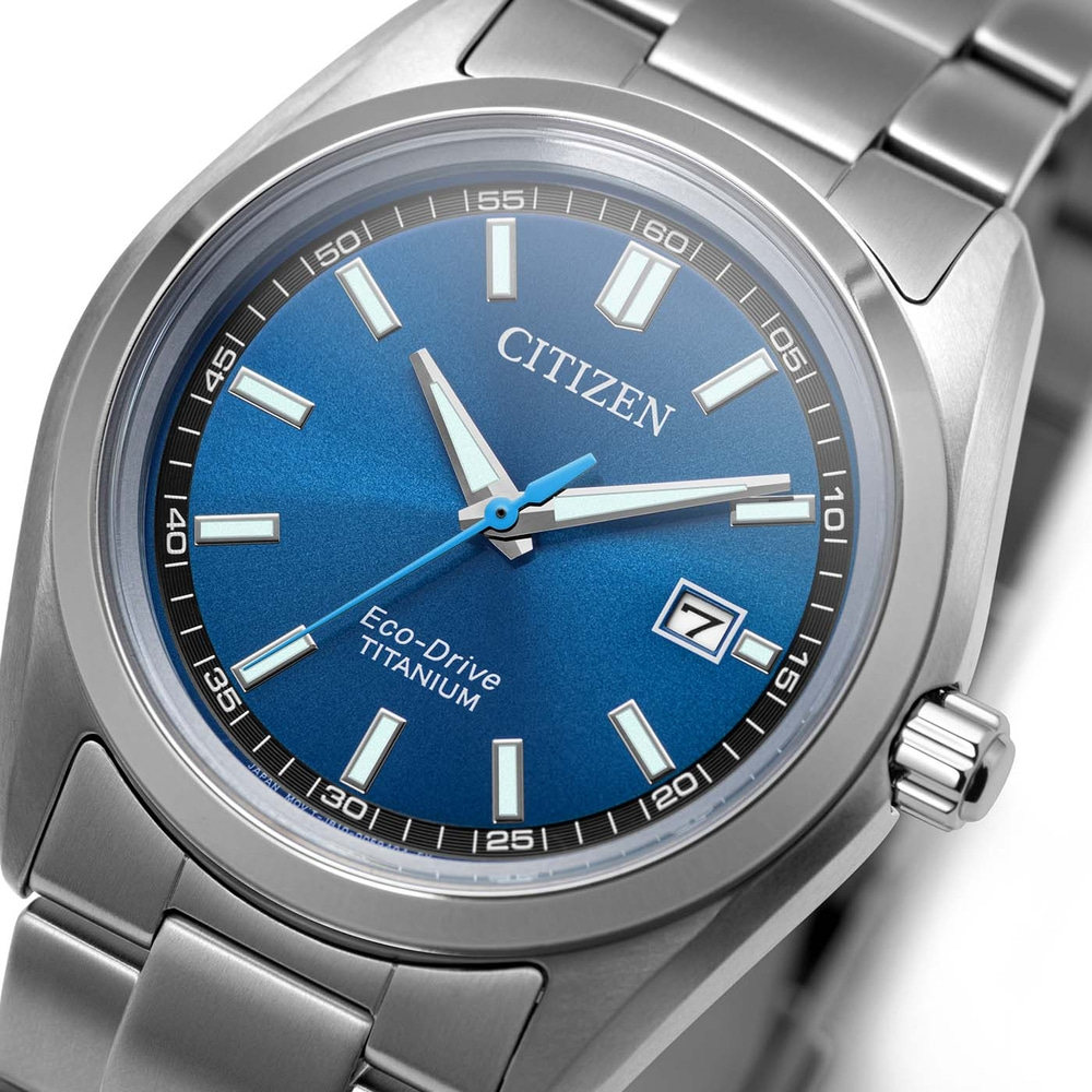 A close-up of a Citizen Eco-Drive Titanium watch with a blue dial and silver band.