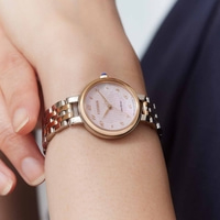 Citizen watch on wrist, pink face, gold and silver band, Eco-Drive, elegant design