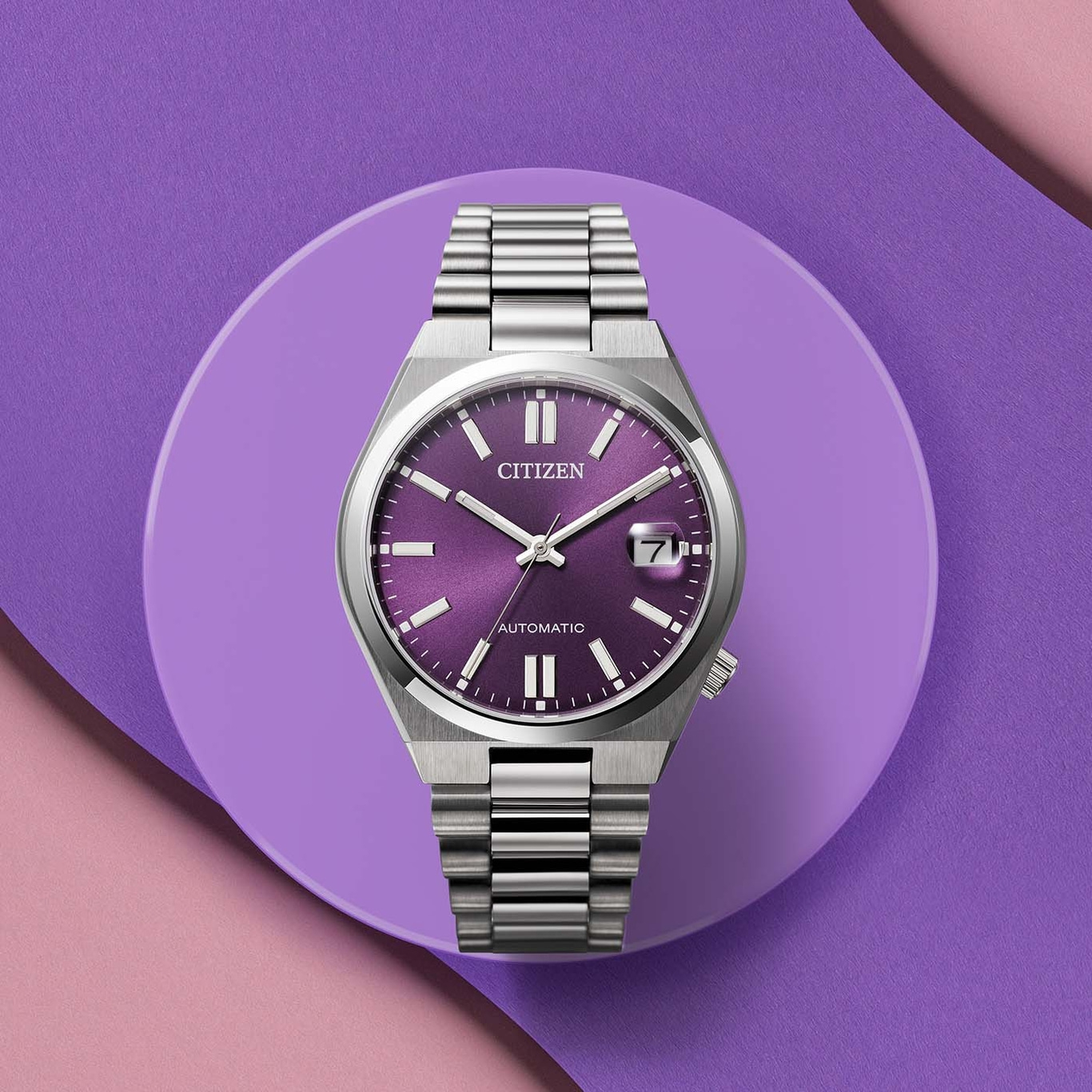 Citizen watch with purple face and silver band on purple background