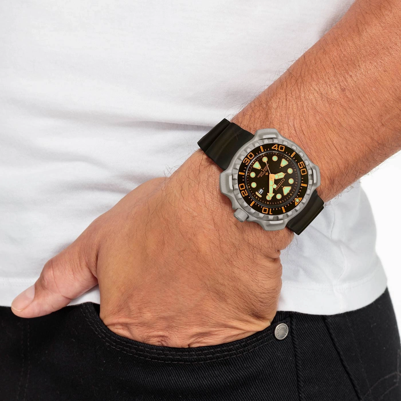 Man wearing a watch, hand in pocket, white shirt, black jeans, close-up shot