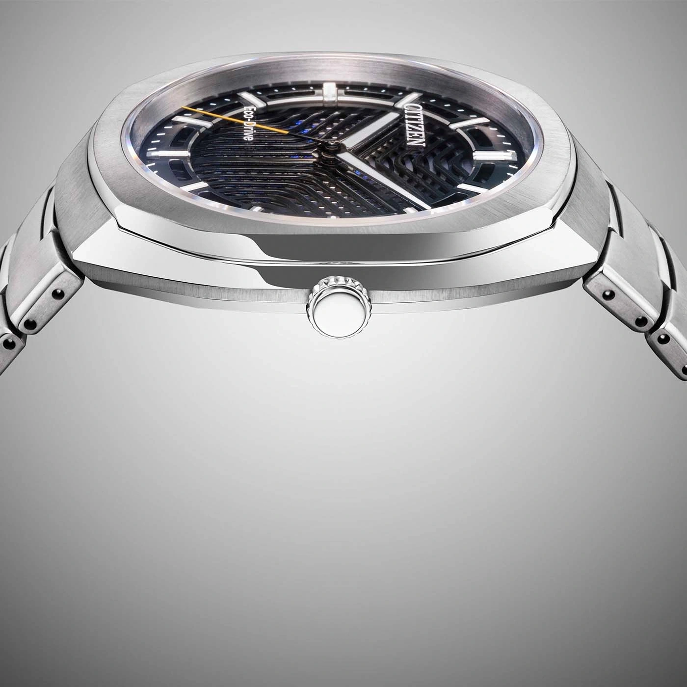 A sleek, modern silver Citizen Eco-Drive watch with a dark, intricate dial.