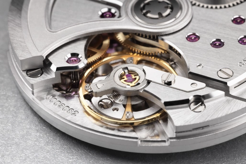 Close-up of a watch mechanism with gears and intricate details.