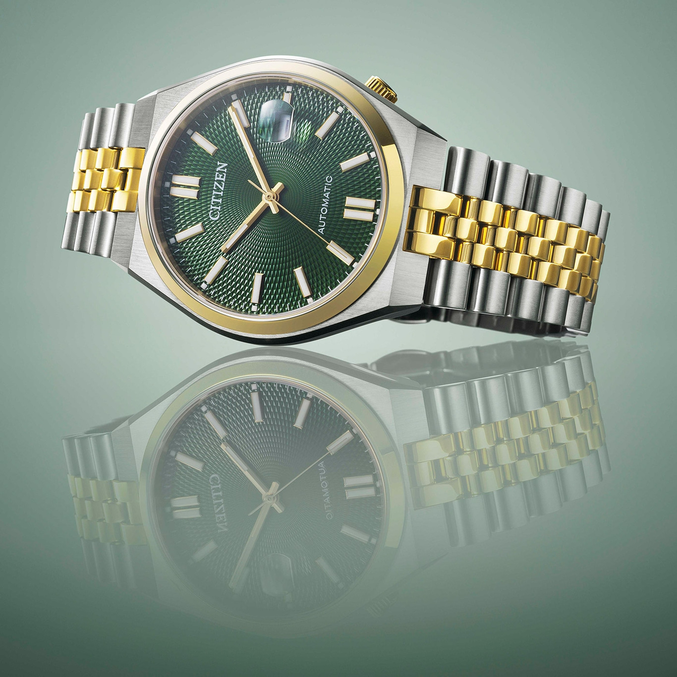 Citizen watch with green dial and gold and silver bracelet