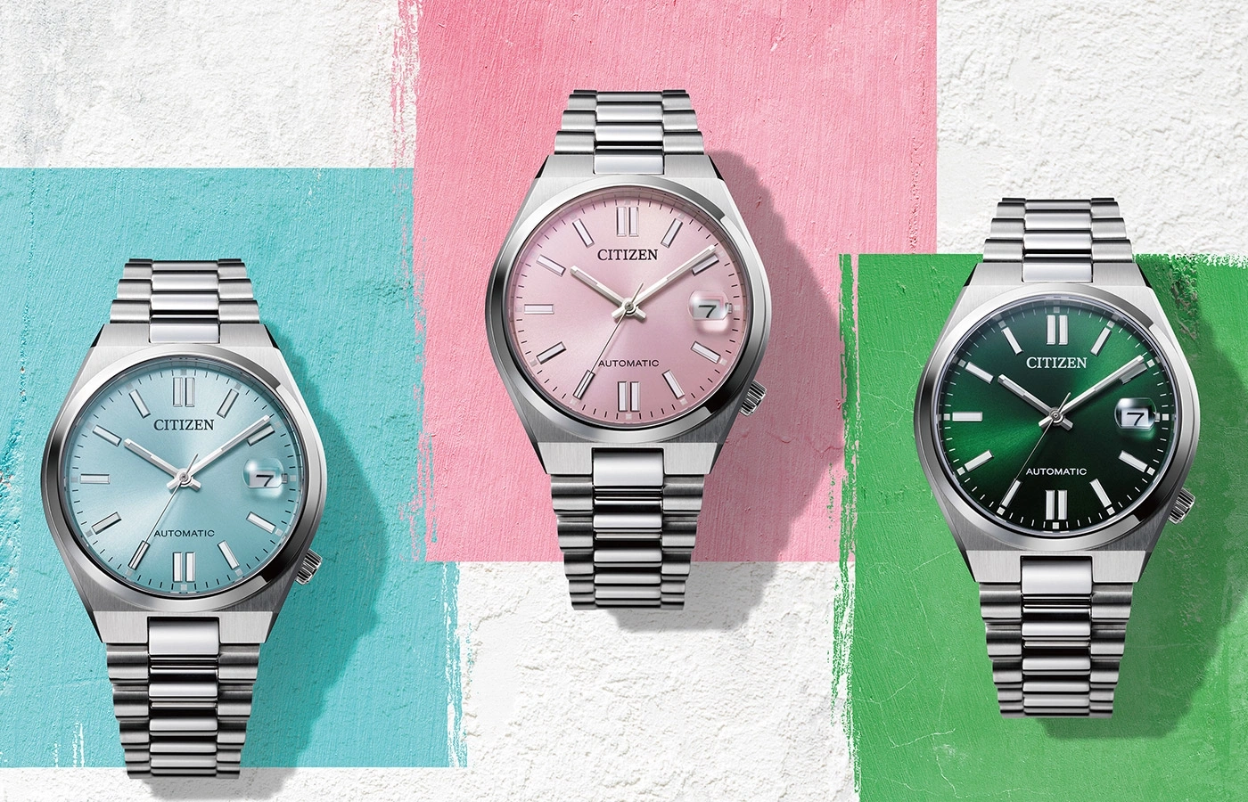 Three Citizen watches with different colored faces and stainless steel bands.
