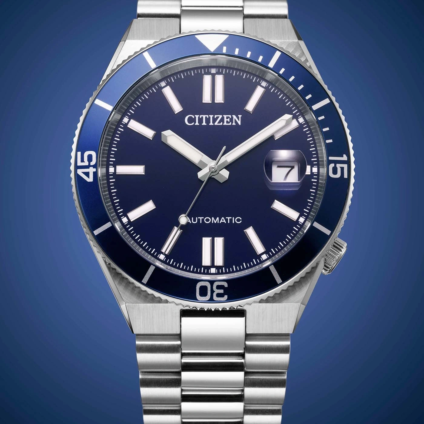 A blue Citizen automatic watch with a stainless steel band and silver markers.
