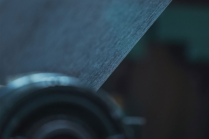 Close-up of a textured, blue surface with blurred background and details.