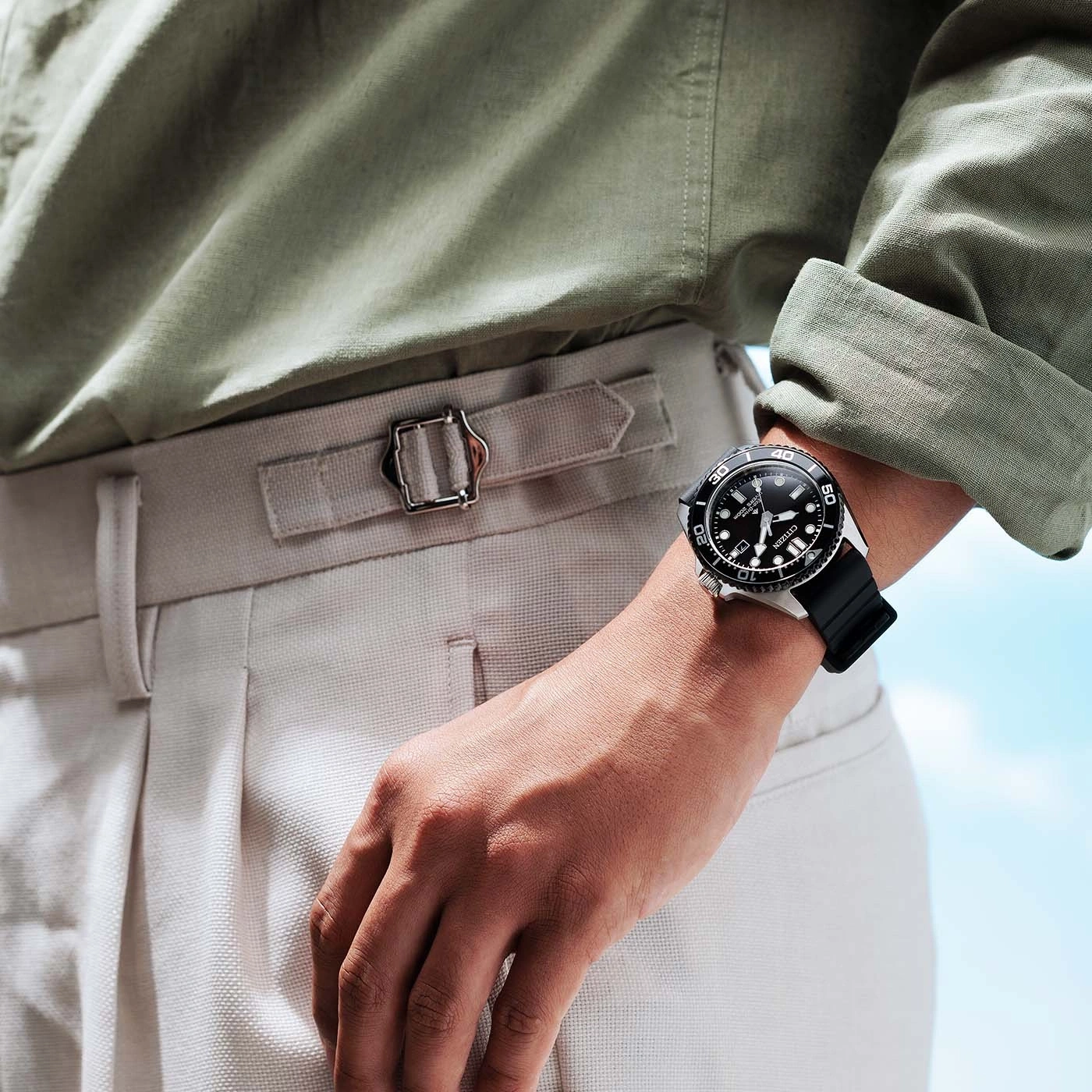 Man wearing a watch and light-colored pants