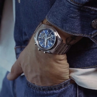 A man wearing a blue citizen watch and denim jacket