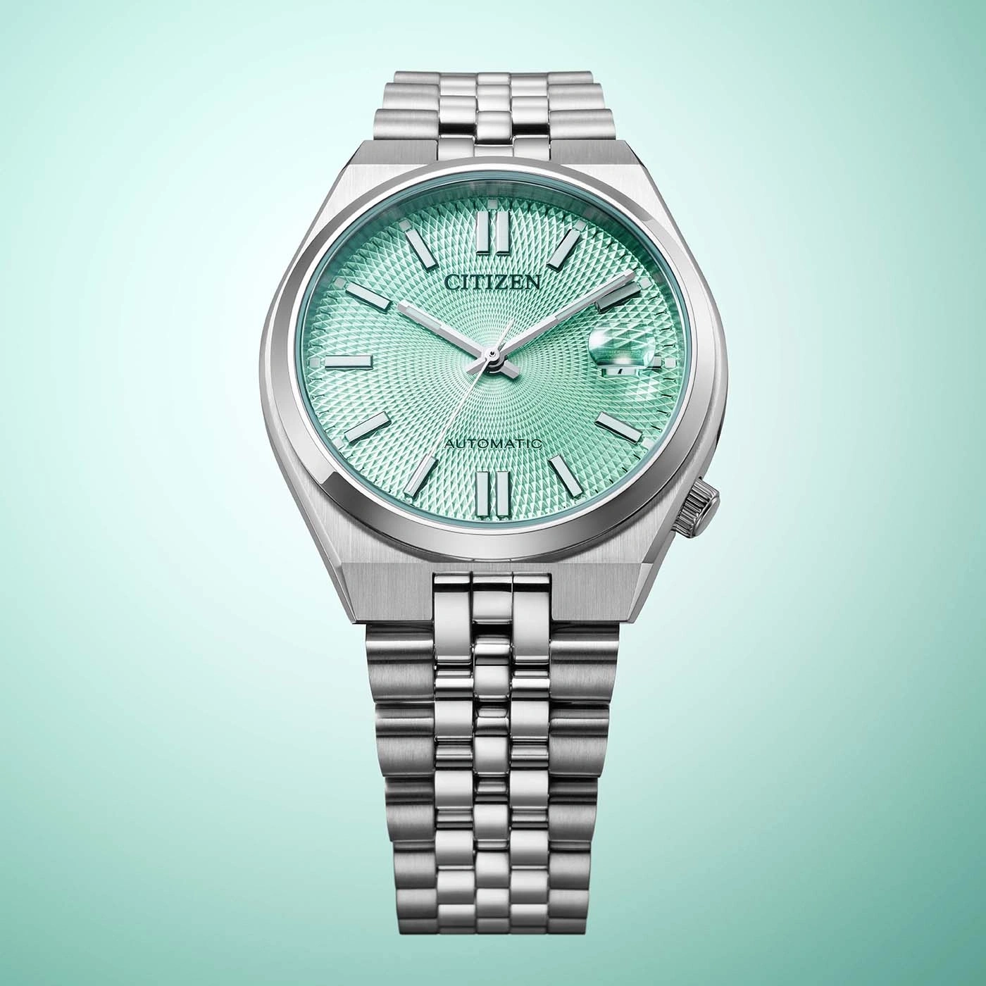 A detailed shot of a citizen automatic watch with a green textured dial and silver band.