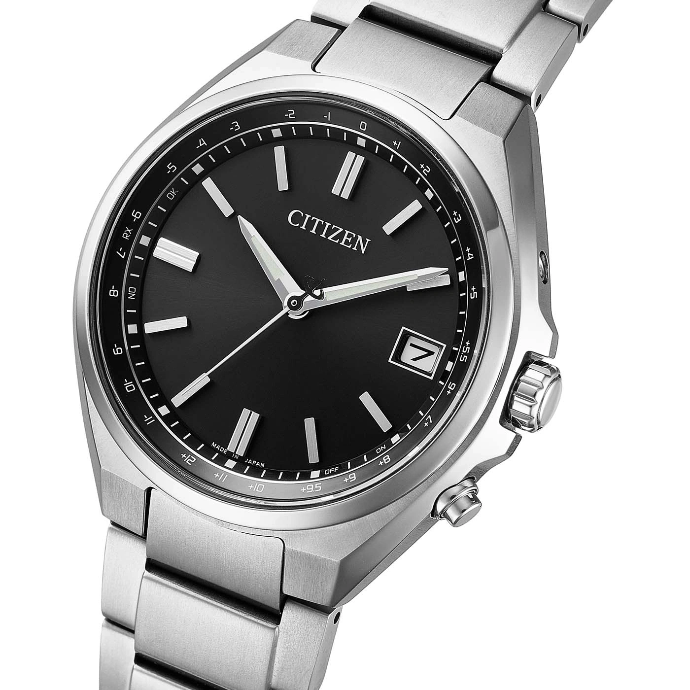 A detailed shot of a silver Citizen watch with a black face and silver hands.