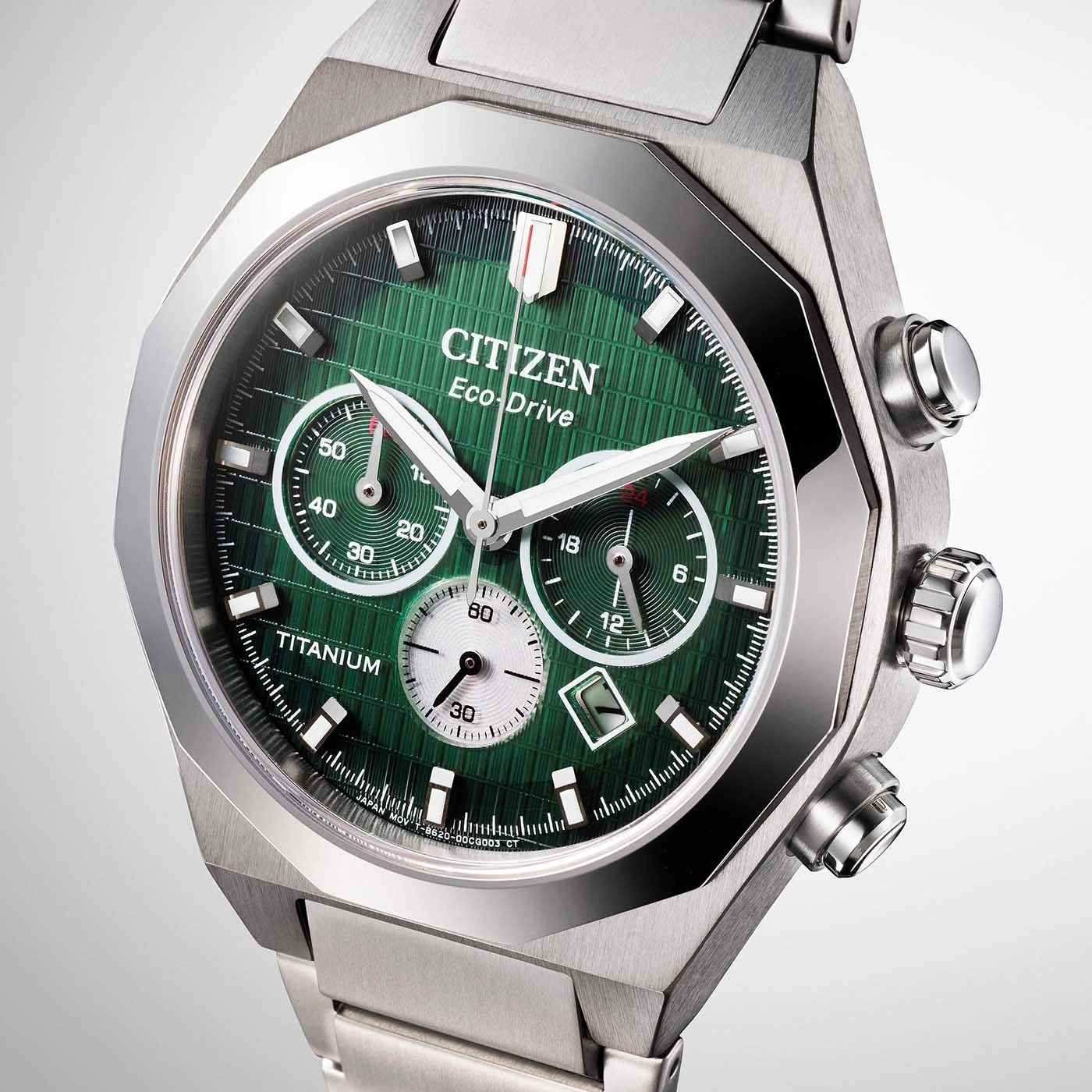 Citizen Eco-Drive watch with green face and titanium case, close-up shot.