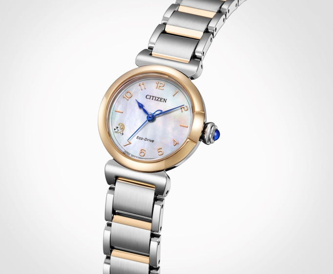 Citizen Eco-Drive watch with gold and silver accents, blue hands, and a mother-of-pearl face.