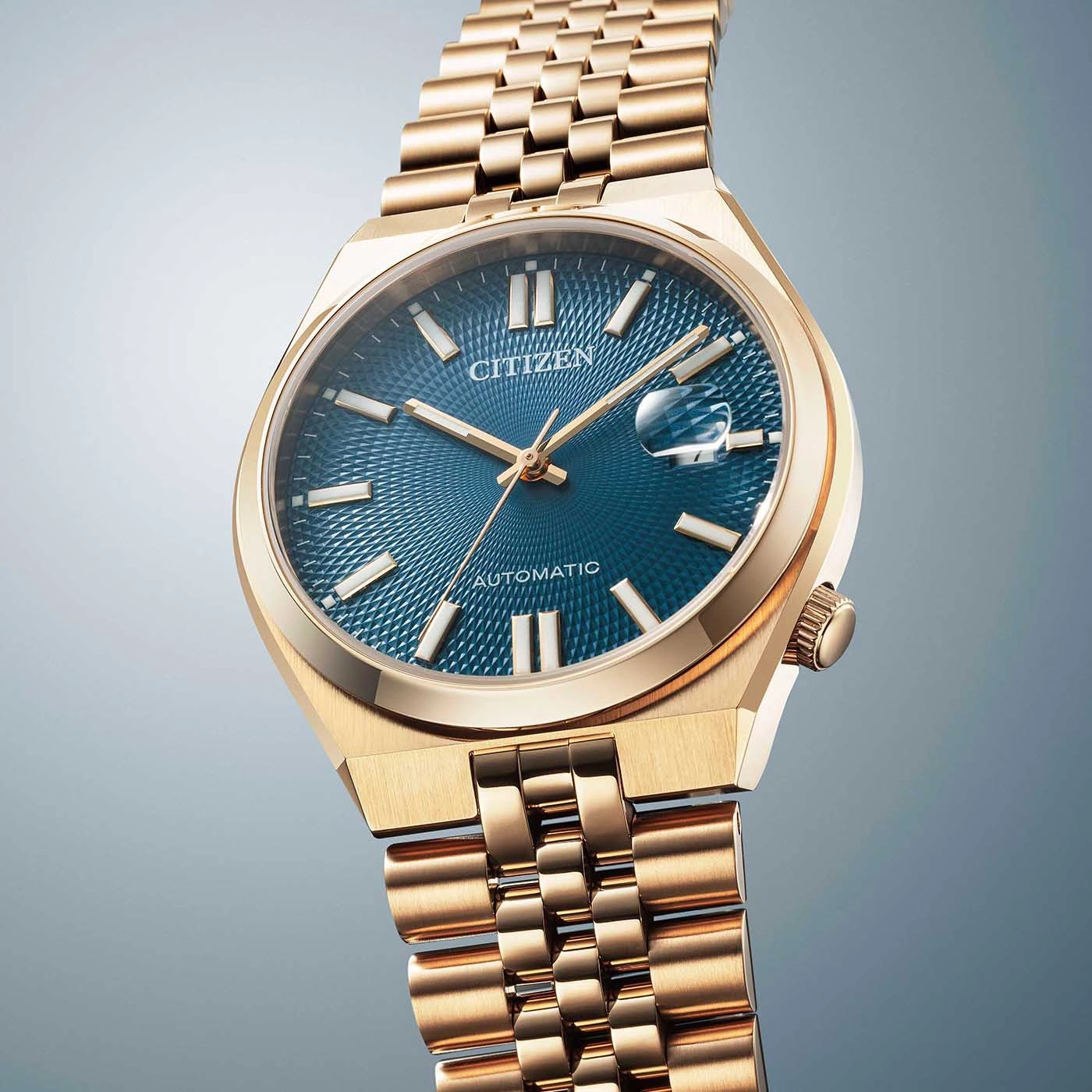 Gold Citizen watch with blue face and gold bracelet, elegant design.