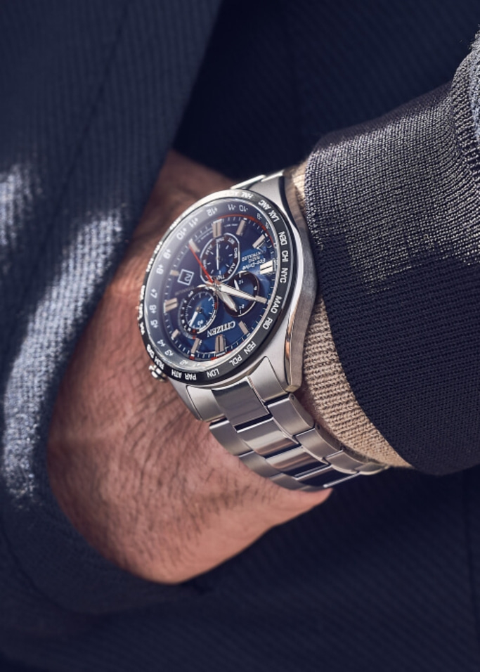 Close-up of a Citizen watch on a wrist, with a blue face and silver band.