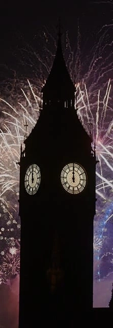 Big Ben silhouette with fireworks at night, clock showing midnight