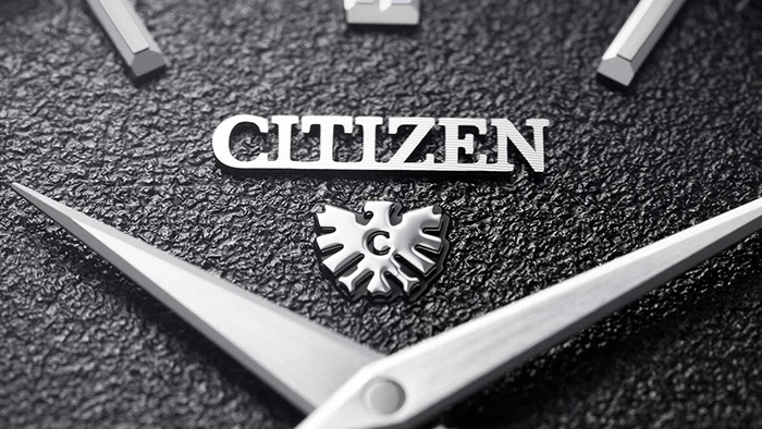 Close-up of a Citizen watch face with the brand name and logo.