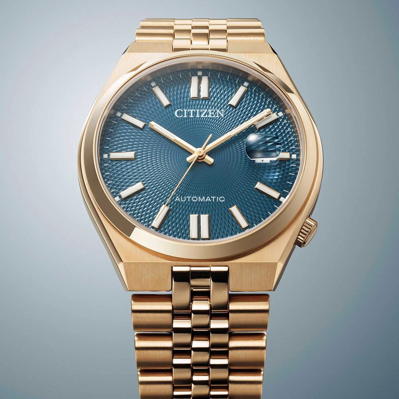 Gold Citizen watch with blue face and automatic movement, elegant design.