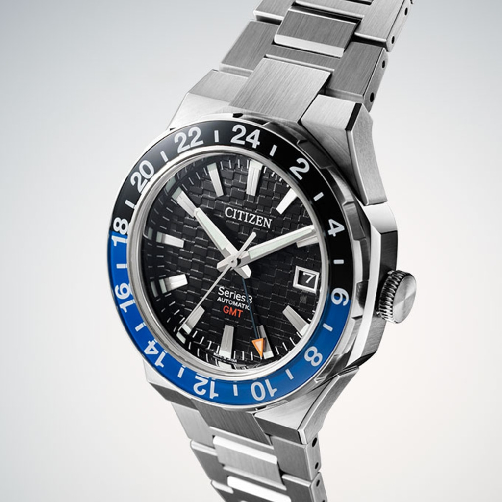 Citizen Series 3 GMT automatic watch with black and blue bezel and steel bracelet.