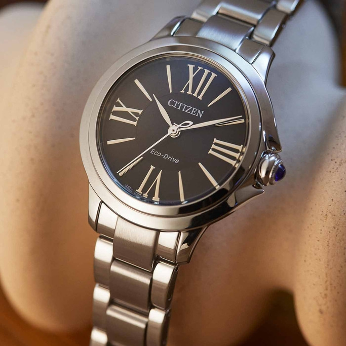 Citizen watch with black face and silver band, Roman numerals.