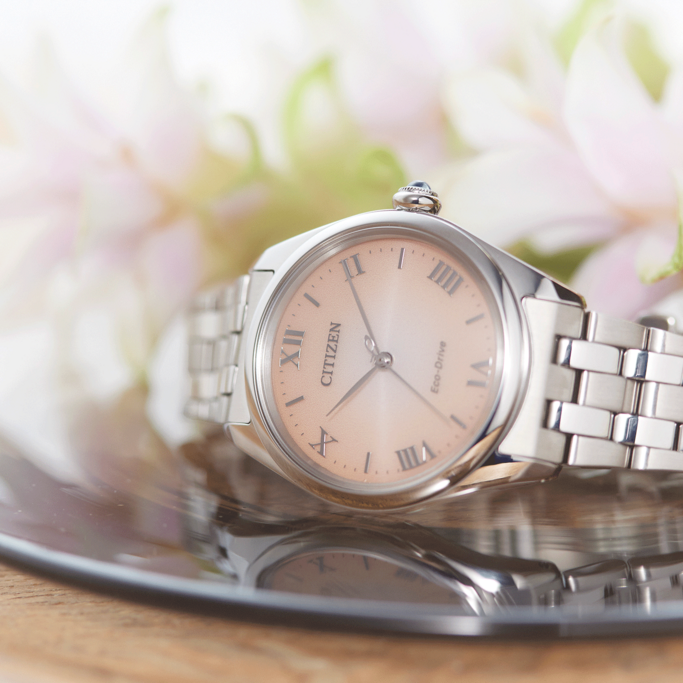 Citizen watch with a pink face and silver band, elegant design.