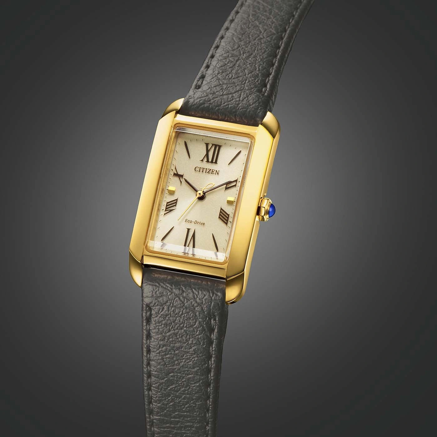 Gold Citizen watch with a rectangular face and a leather strap.