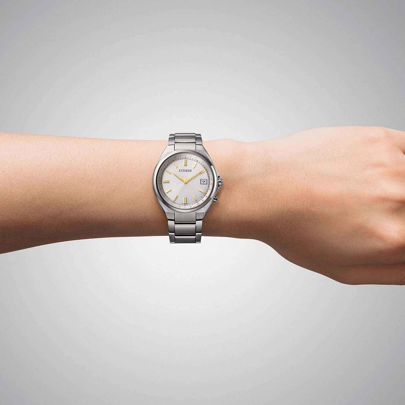 A silver Citizen watch on a person's wrist.
