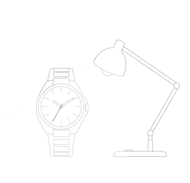 Watch illuminated by a desk lamp, showing the time on its face.