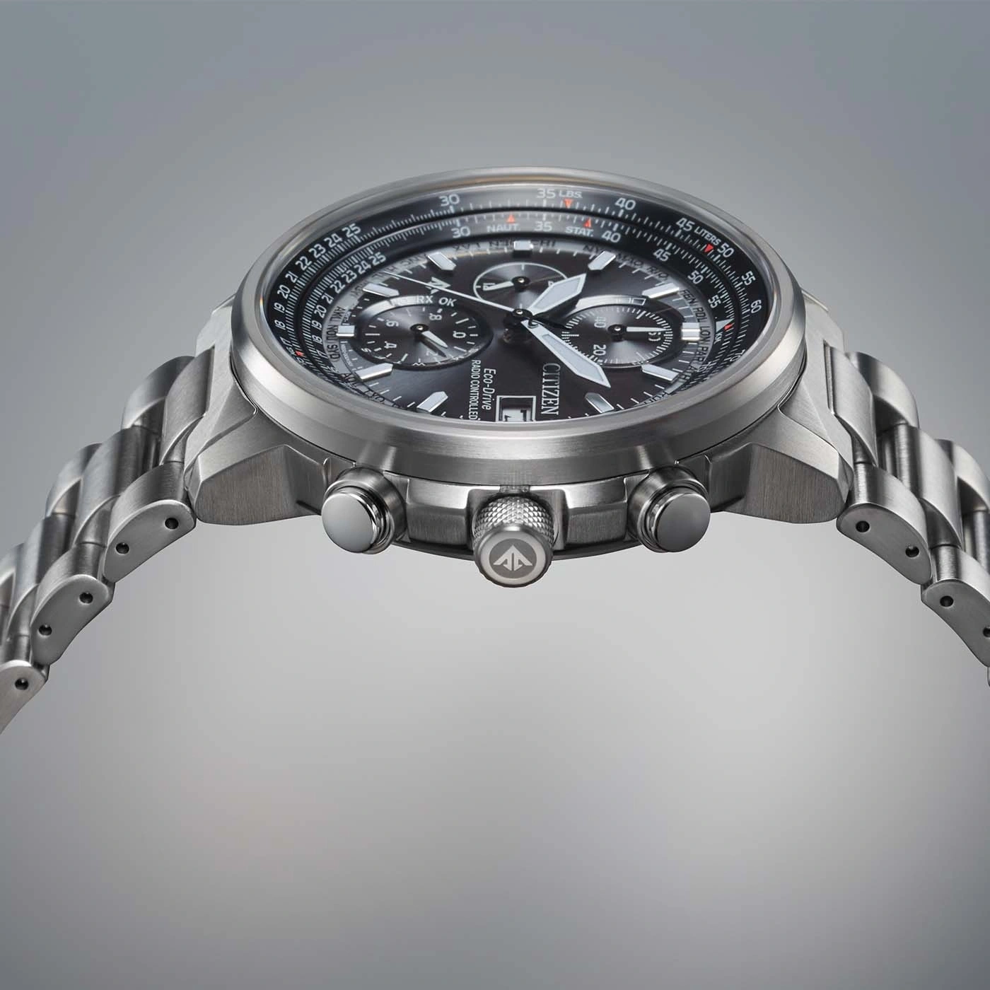 Citizen watch with a black dial and silver band, close-up shot.