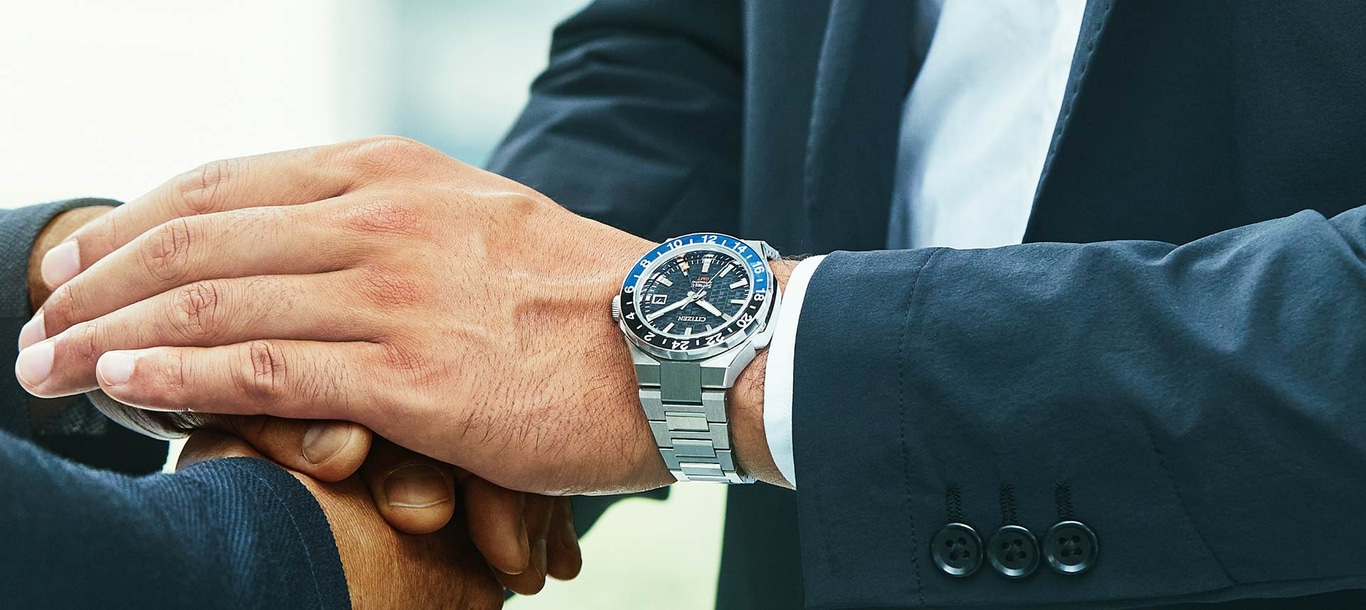 Man wearing a watch, shaking hands, business attire, close-up shot, deal