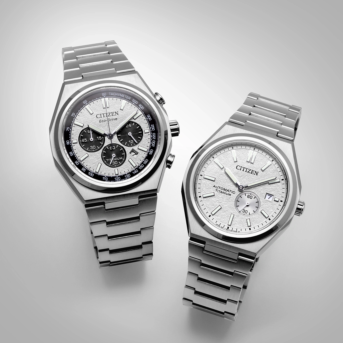 Two Citizen watches, silver, titanium, Eco-Drive and Automatic, on a white background.