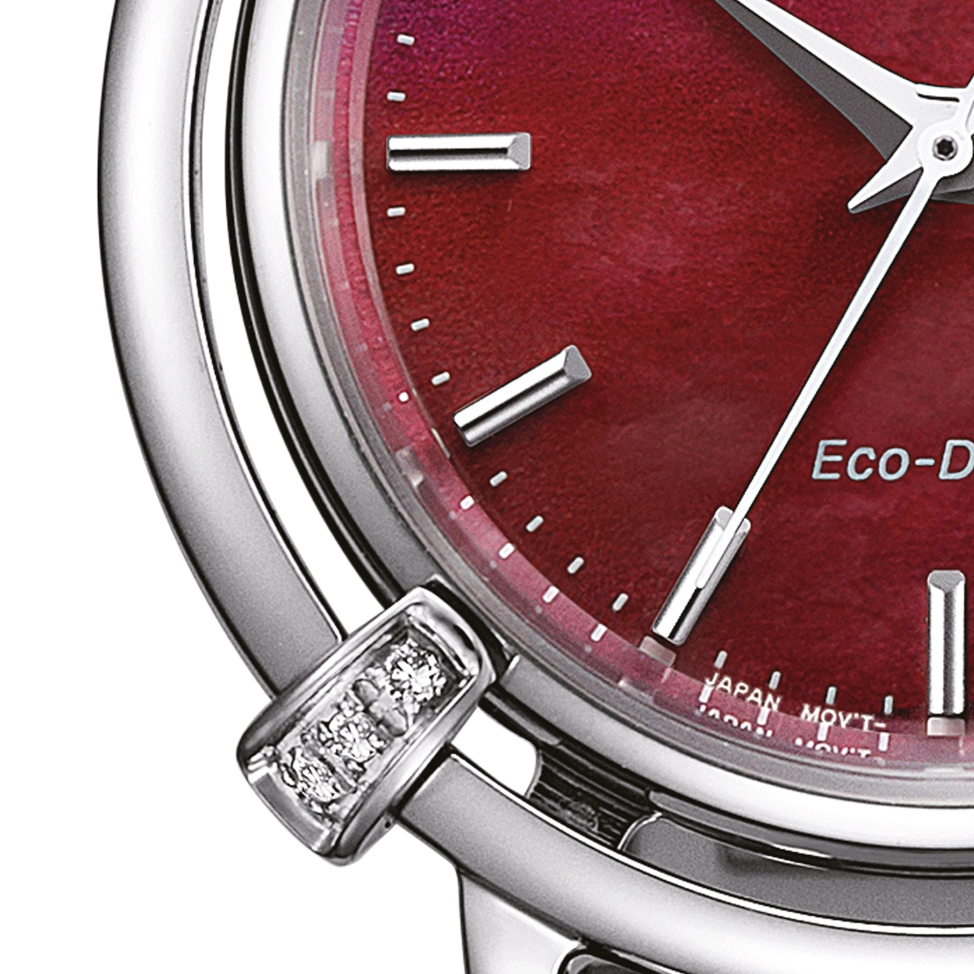 Close-up of a red watch face with silver accents and diamonds