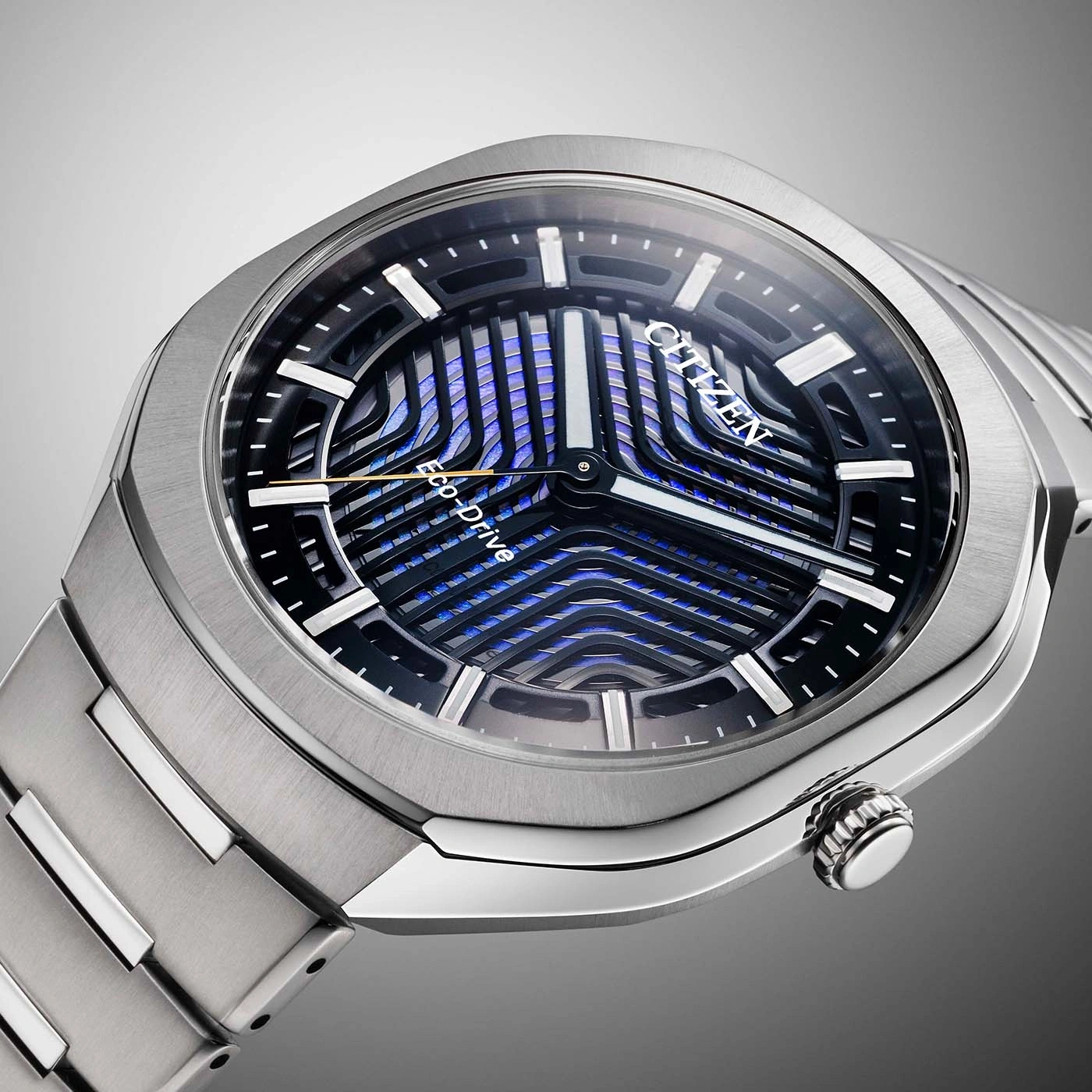 A close-up shot of a modern Citizen Eco-Drive watch with a detailed blue and black dial and silver bracelet.