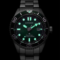 Citizen Eco-Drive Diver's watch with green luminous dial and black bracelet.