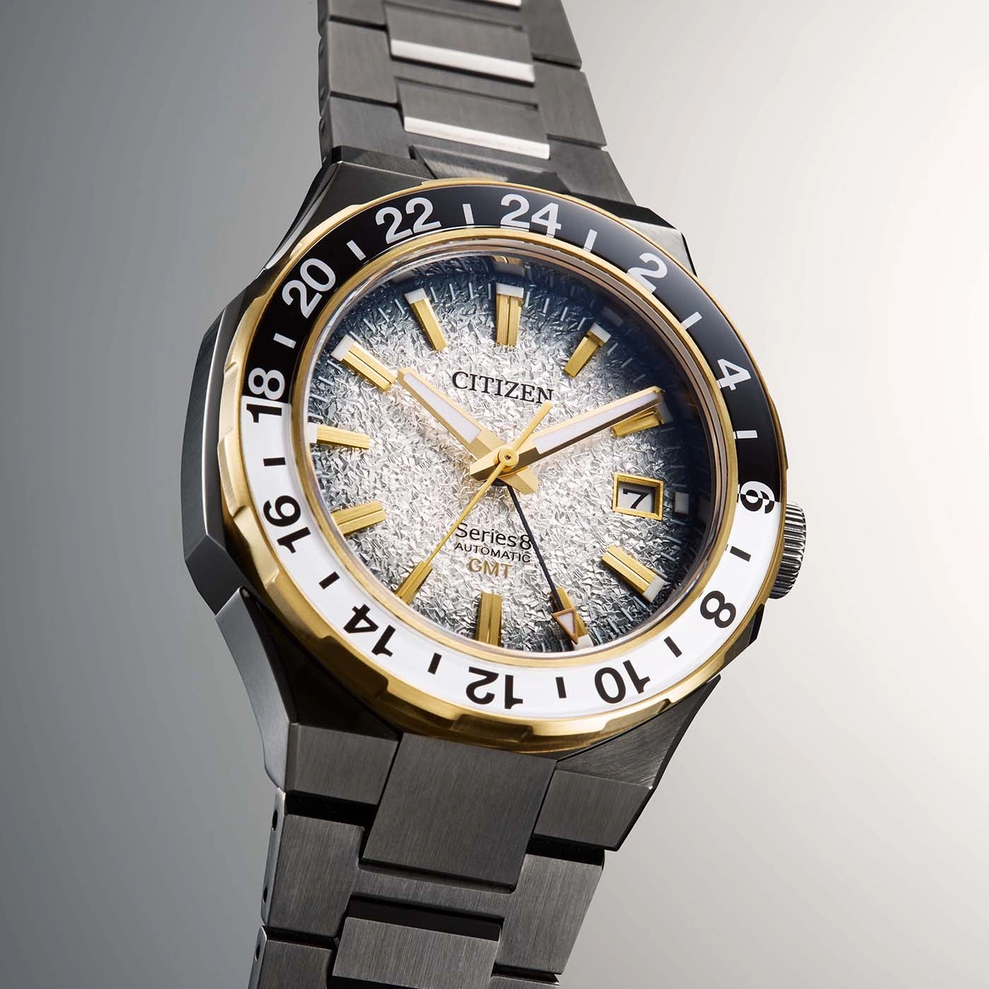 Citizen watch with gold accents and a textured face, GMT function.