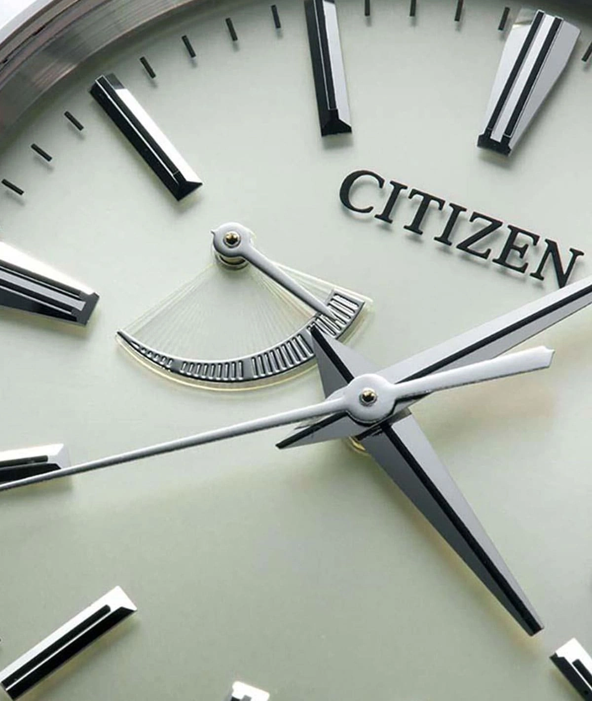 Close-up of a Citizen watch face with hands and a unique dial design.