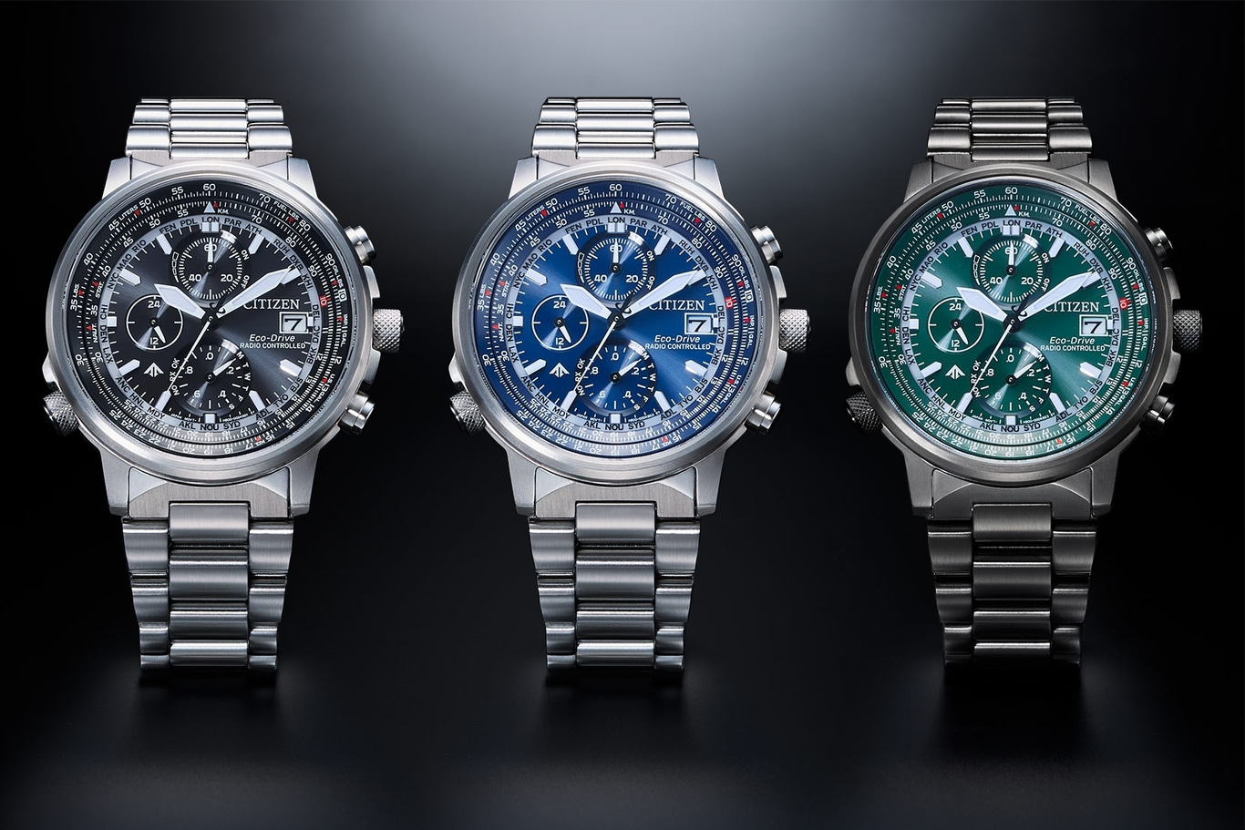 Three Citizen watches with different colored faces and stainless steel bands.