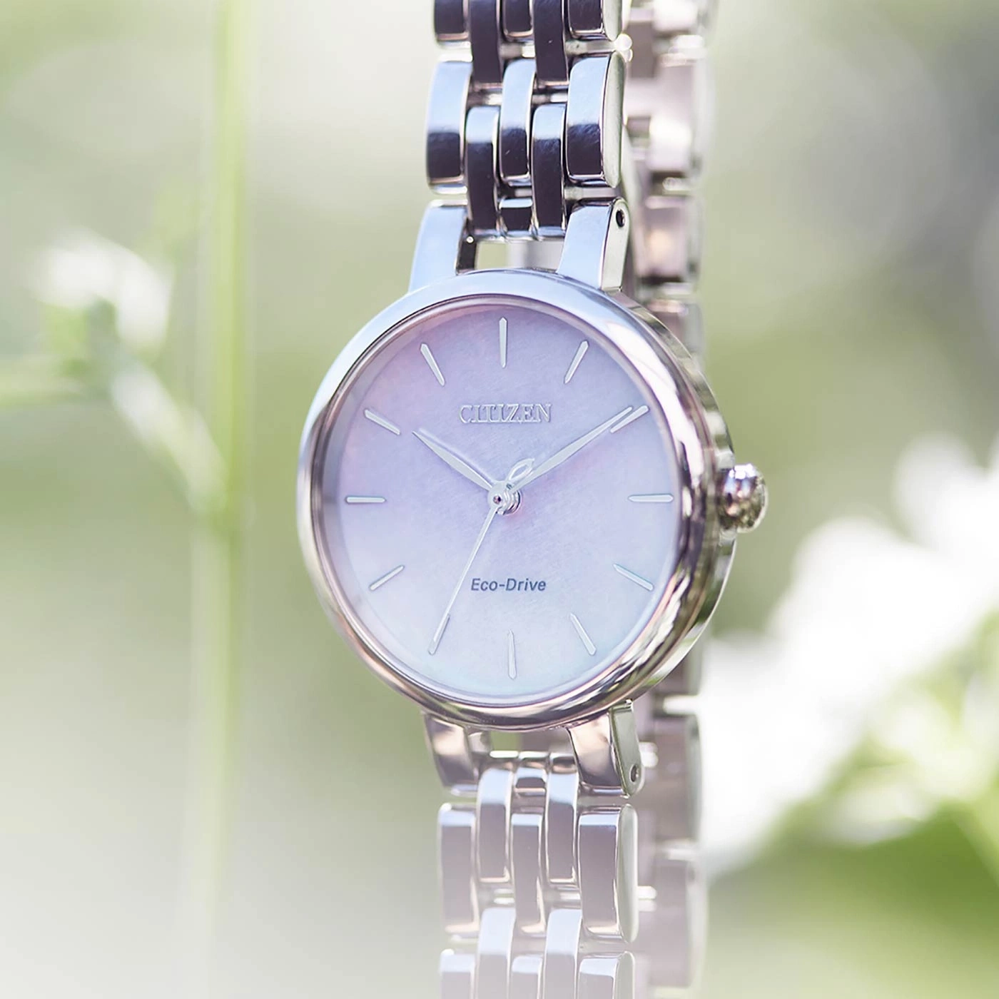 Citizen Eco-Drive watch with a silver band and a light purple face.