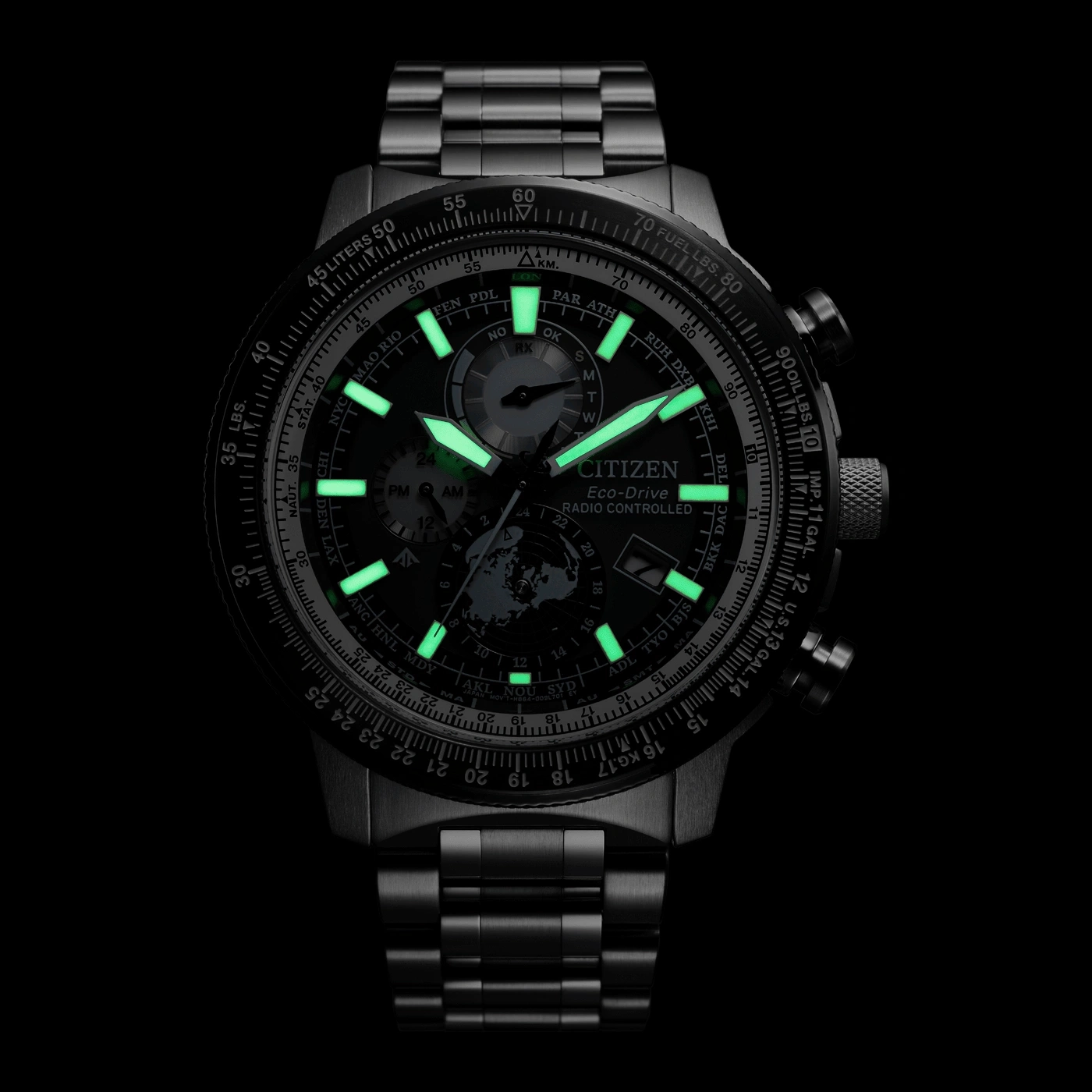 Citizen Eco-Drive watch with glowing hands and markers on a black background.