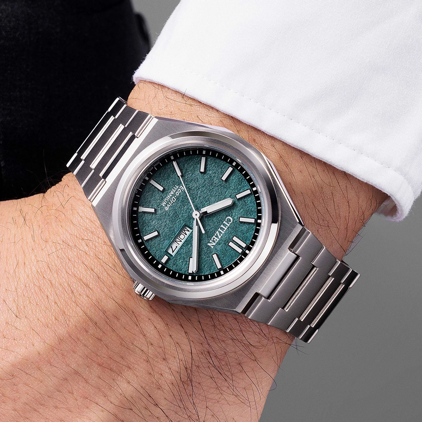Citizen watch on wrist, green dial, titanium, modern design, close-up shot