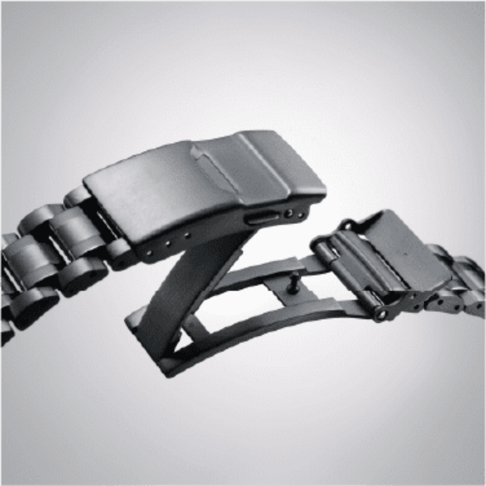 Close-up of a black watch strap clasp, open and ready to close.