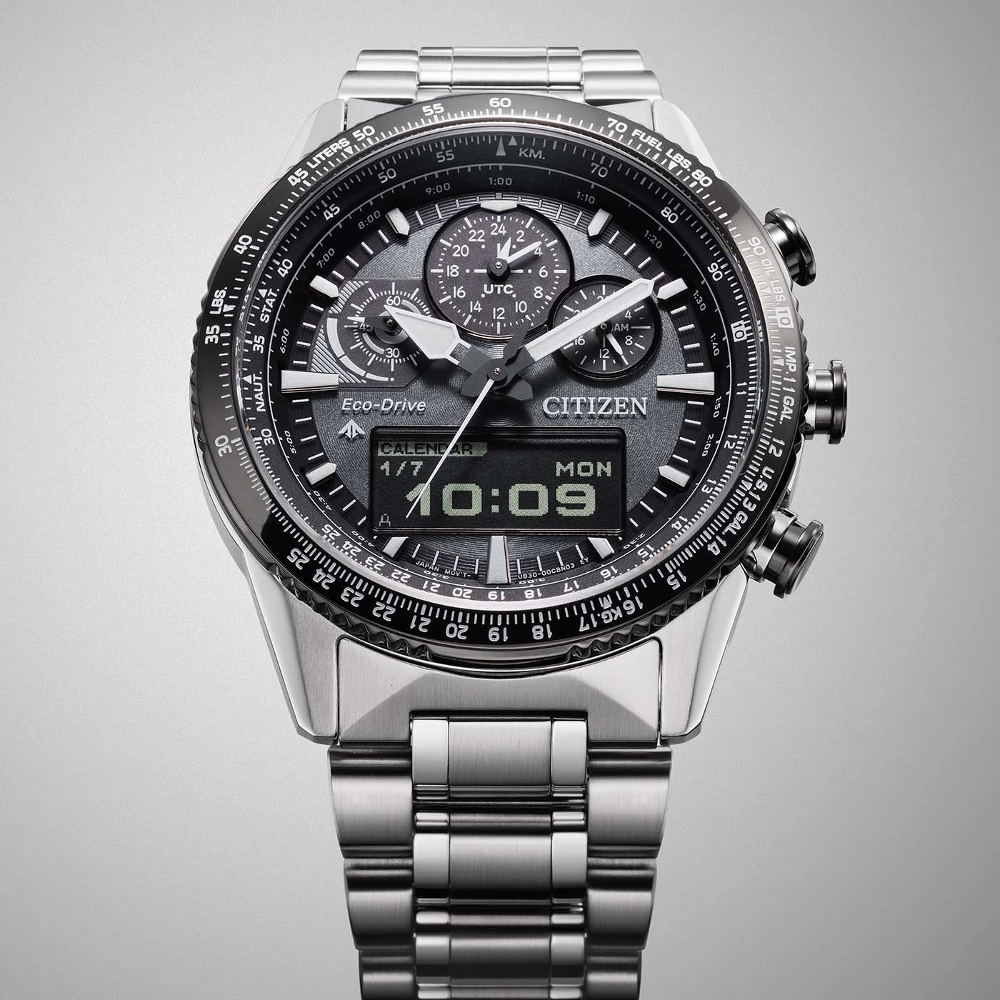 Citizen watch with black dial, calendar, and time display, stainless steel band
