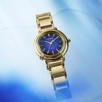 Gold Citizen watch with a blue face on a blue background.