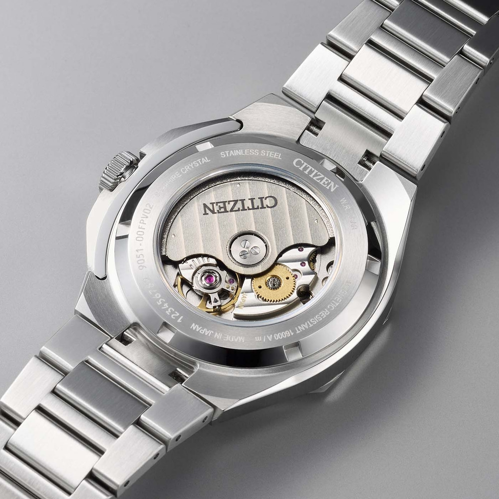 Back of a Citizen watch with visible movement and metal band.