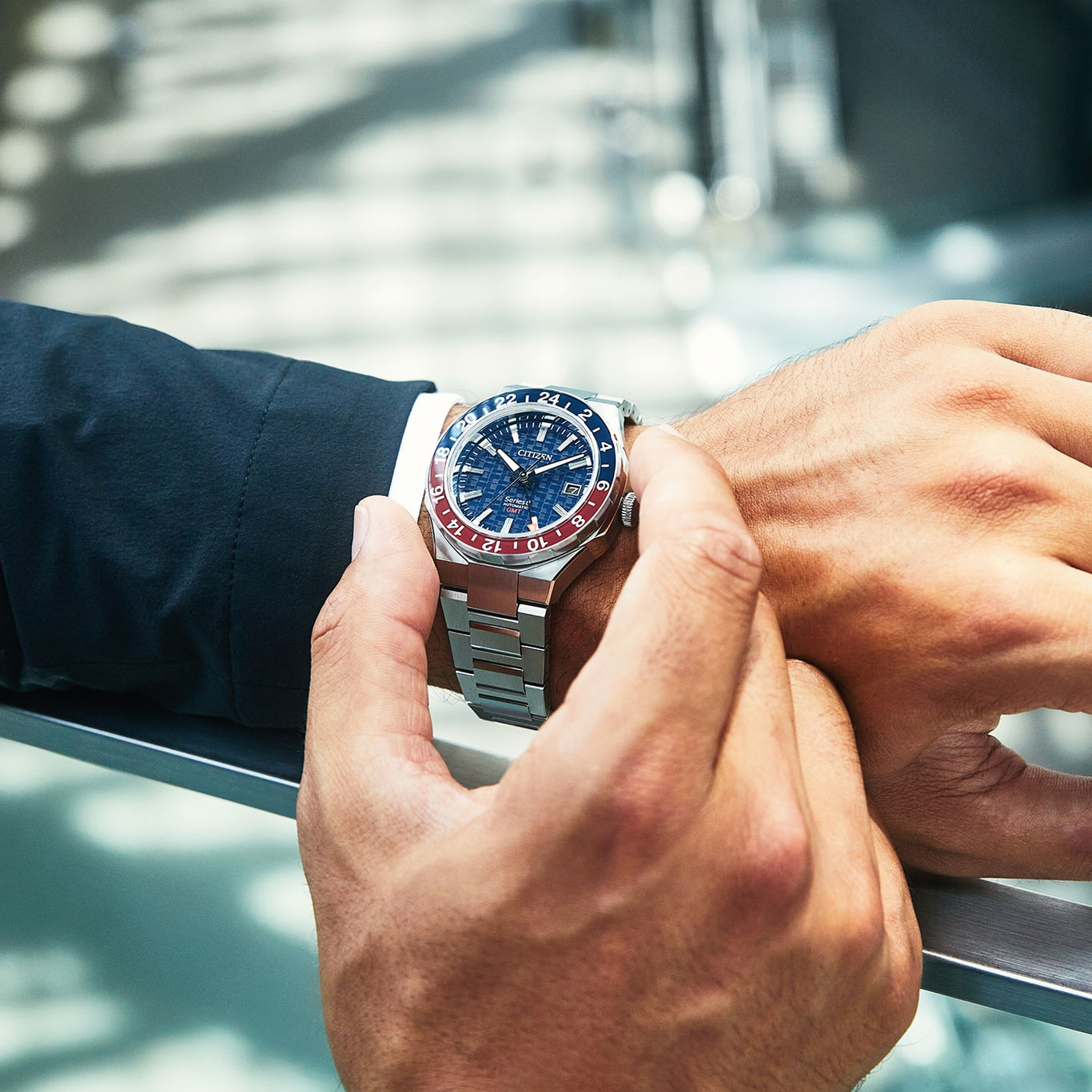Man wearing a Citizen watch, close-up shot of the wrist and watch.