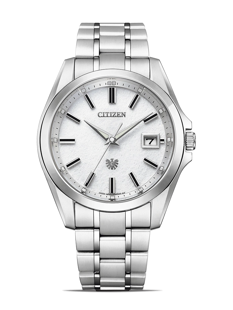 Citizen watch with a white face and silver band on a green background