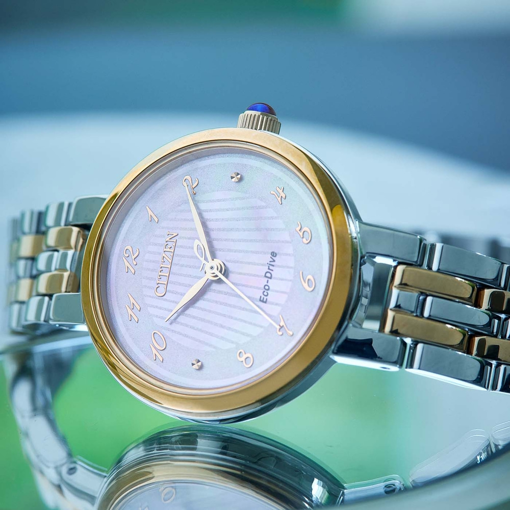 Citizen watch with gold and silver accents, close-up shot, elegant design