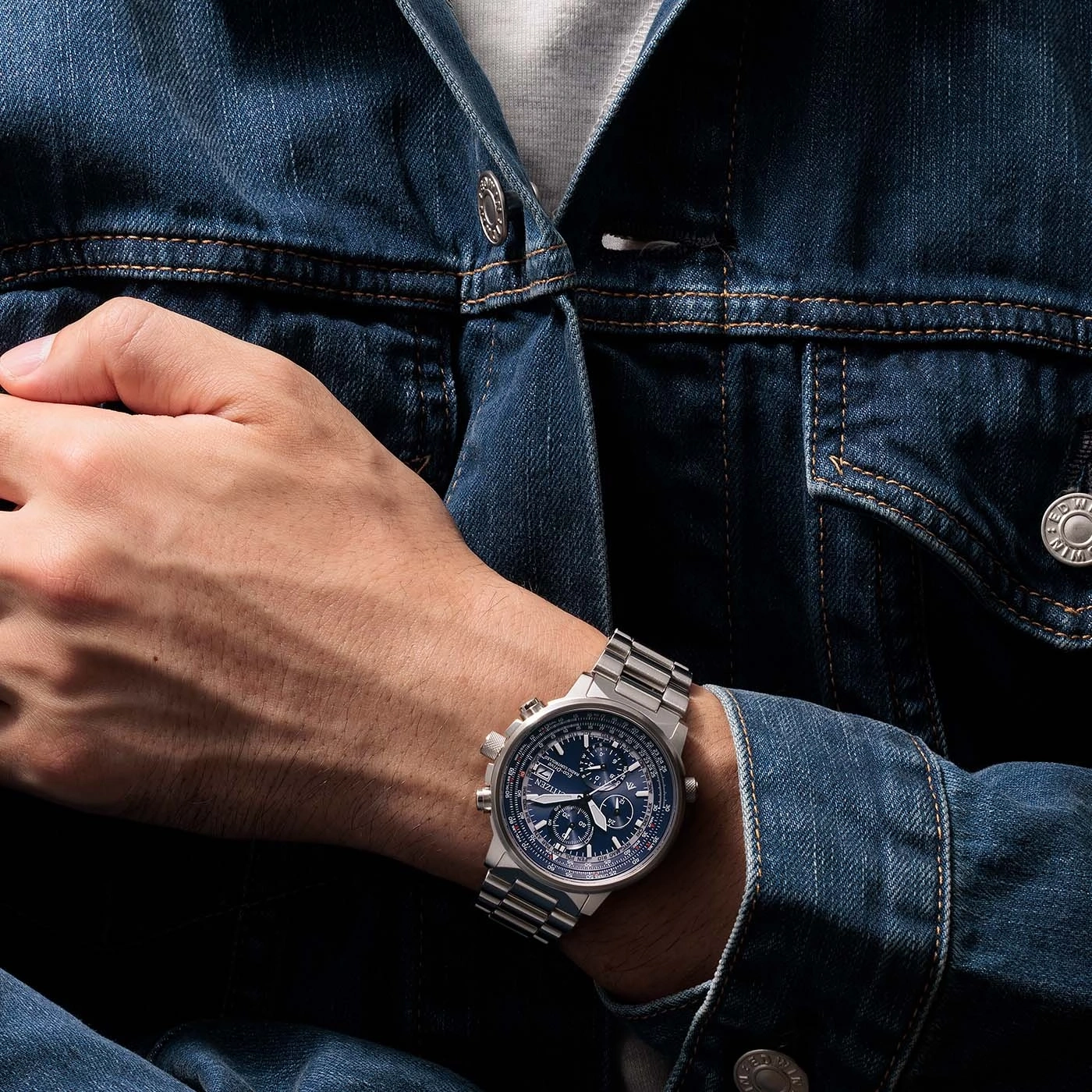 Man wearing a watch on his wrist, denim jacket, close-up shot