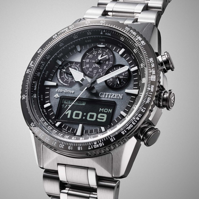 Citizen watch with multiple dials, digital display, and stainless steel band, showing time and date.